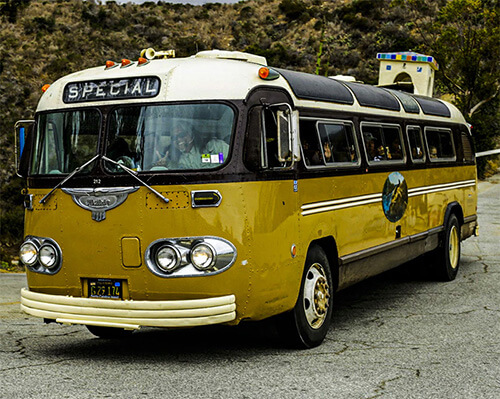 A beautifully restored vintage bus, with tourists, on Catalina Island.