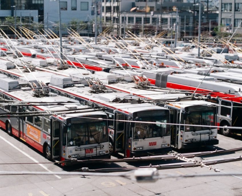 A parking lot full of city buses.