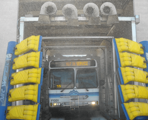 Bus passing through automated wash system